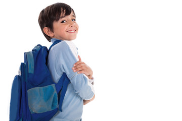 Happy young boy ready for school with his bag