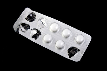 used packaging of pills, black background, isolated