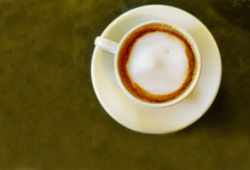cappuccino coffee from above, on textured table