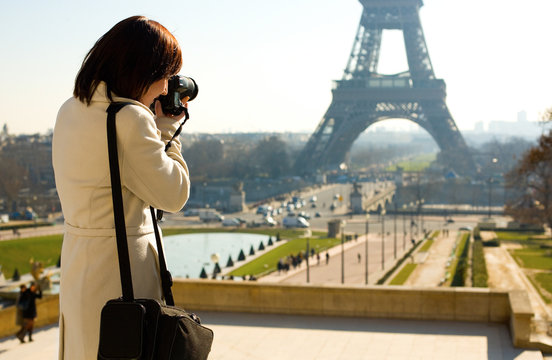 Tourist taking a picture of the Eiffel Tower in Paris