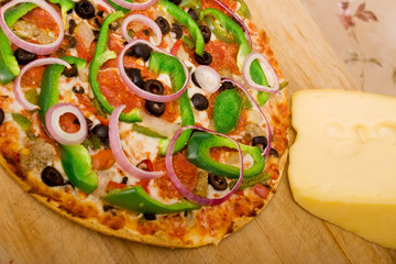 Supreme pizza with pepperoni and vegetables