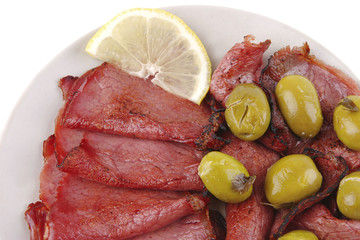 sliced served sausage with raw lemon