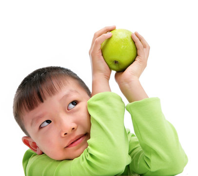 asian boy holding a big green apple