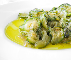 Courgettes sliced thinly and cooked with olive oil and onions.