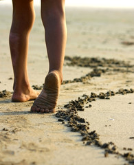 small girl and her legs on the beach