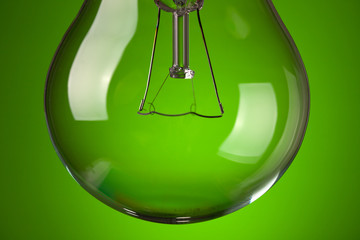 detail of light bulb on green background