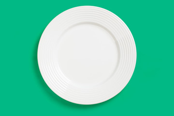 white plate on green background
