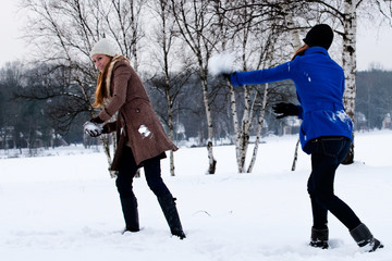 Fototapeta na wymiar sisters snow ball fight