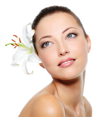 Beautiful woman face with a flower