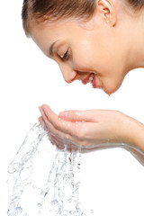 young woman washing her face with a clean water
