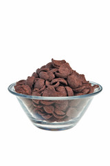Chocolate flakes in transparent bowl over white background.