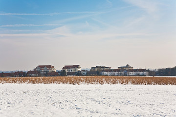 beautiful landscape with water tower and housing area in winter