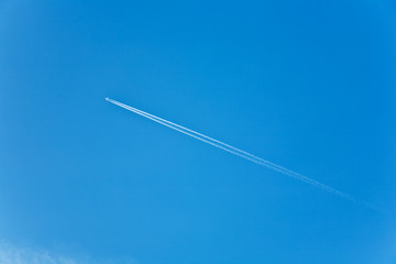 beautiful blue sky with condension trail of an aircraft