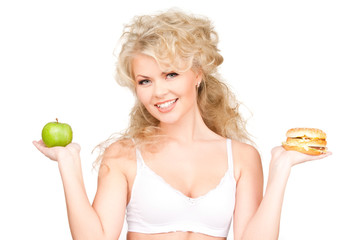 woman choosing between burger and apple