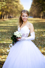 Beautiful young bride in a park