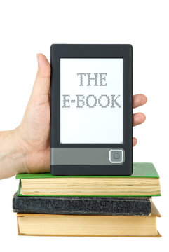 Hand put e-book reader on top of classic paper books
