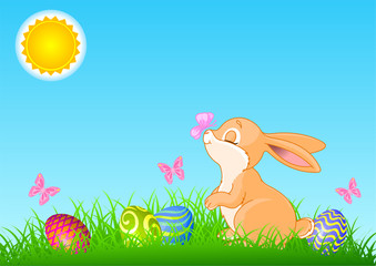 Easter bunny  near colored eggs.