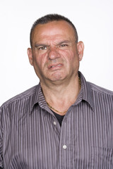 Fototapeta premium Portrait of Mid Adult Male with Repugnant Expression. Isolated.