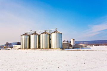 Obraz premium beautiful landscape with silo and snow white acre with blue sky