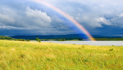 Colors rainbow over lake and fields