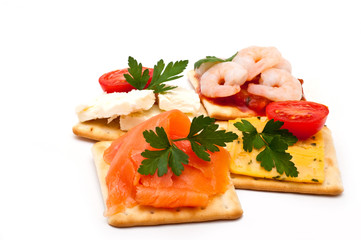 Cheese, salmon, prawns on crackers