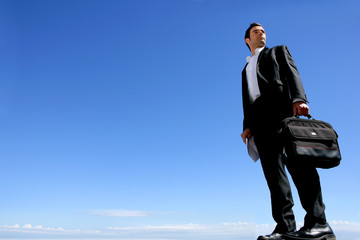 homme en costume et sacoche regardant au loin