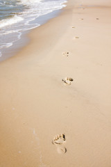 Barefoot footprints on beach