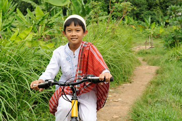 Muslim Kid riding bicycle