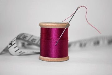 needle, thread and tape measure