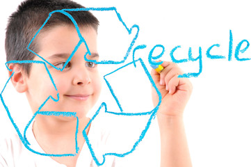 Little boy painting a recycle sign on glass