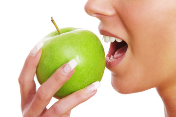 Frau beißt in grünen Apfel