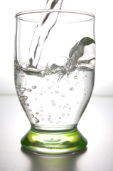 Fresh water pouring in a transparent glass