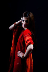 Pretty woman in red arranging her hair