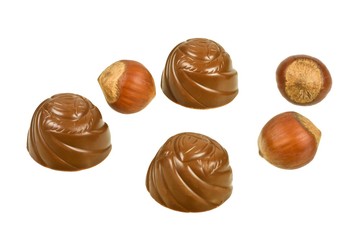 Chocolates and hazelnuts isolated on a white background