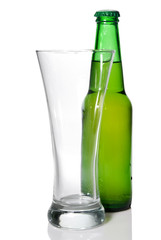 Beer bottle and empty glass isolated on white