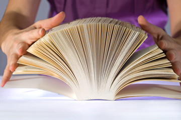 woman reading a very thick book