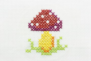 Embroidery of the image of a mushroom