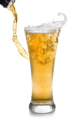 Beer pouring from bottle into glass isolated on white