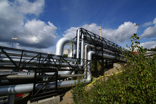 industrial pipelines on pipe-bridge against blue sky