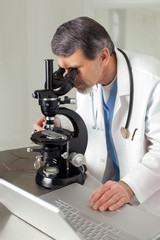 Doctor at Microscope and Computer