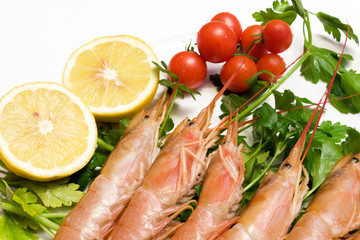 Plate with prawns parsley cherry tomatoes and lemon