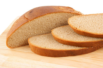 Slices of rye-bread on cutting board isolated