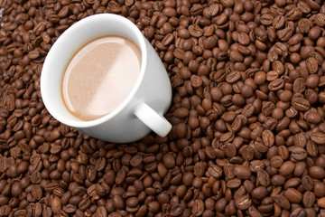 Cup with coffee, costing on coffee grain