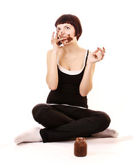 Young beautiful glutton eat chocolate isolated on white