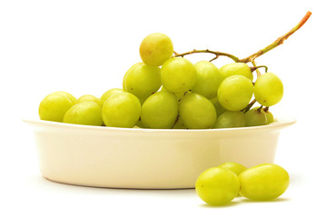 Grapes in bowl isolated on white background with shadows