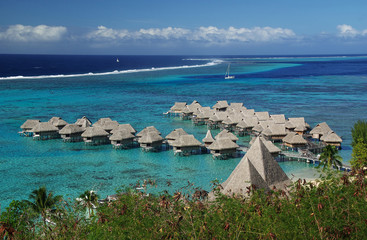 Hotel over a turquoise lagoon in Bora Bora, French Polynesia - obrazy, fototapety, plakaty
