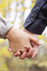 Young Love - Couple holding hands outside