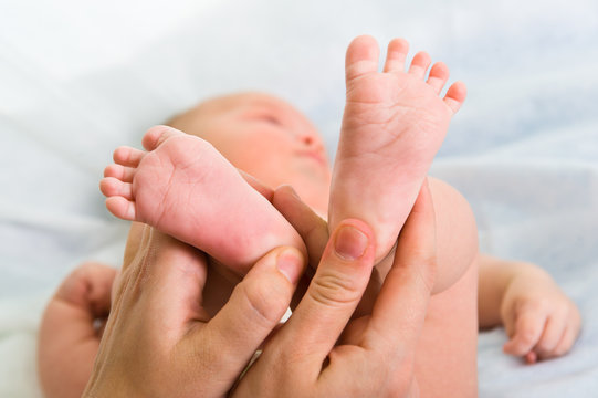 Newborn baby's feet in parent hand