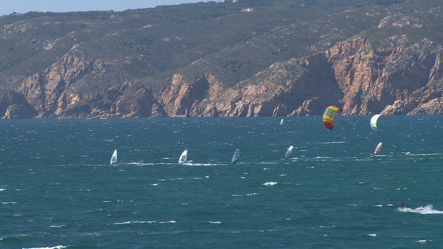 Kitesurfers in action on beach