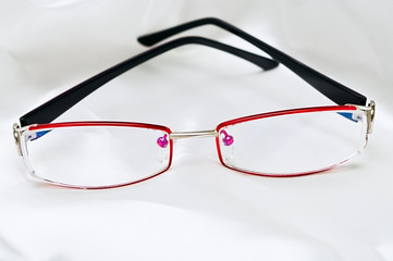 Glasses on white silk background